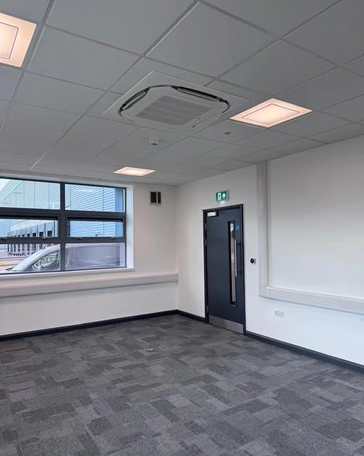 Completed office interior with a ceiling cassette air conditioning installation